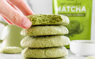 Photo of stacked sugar cookies baked with matcha green tea powder on a white background